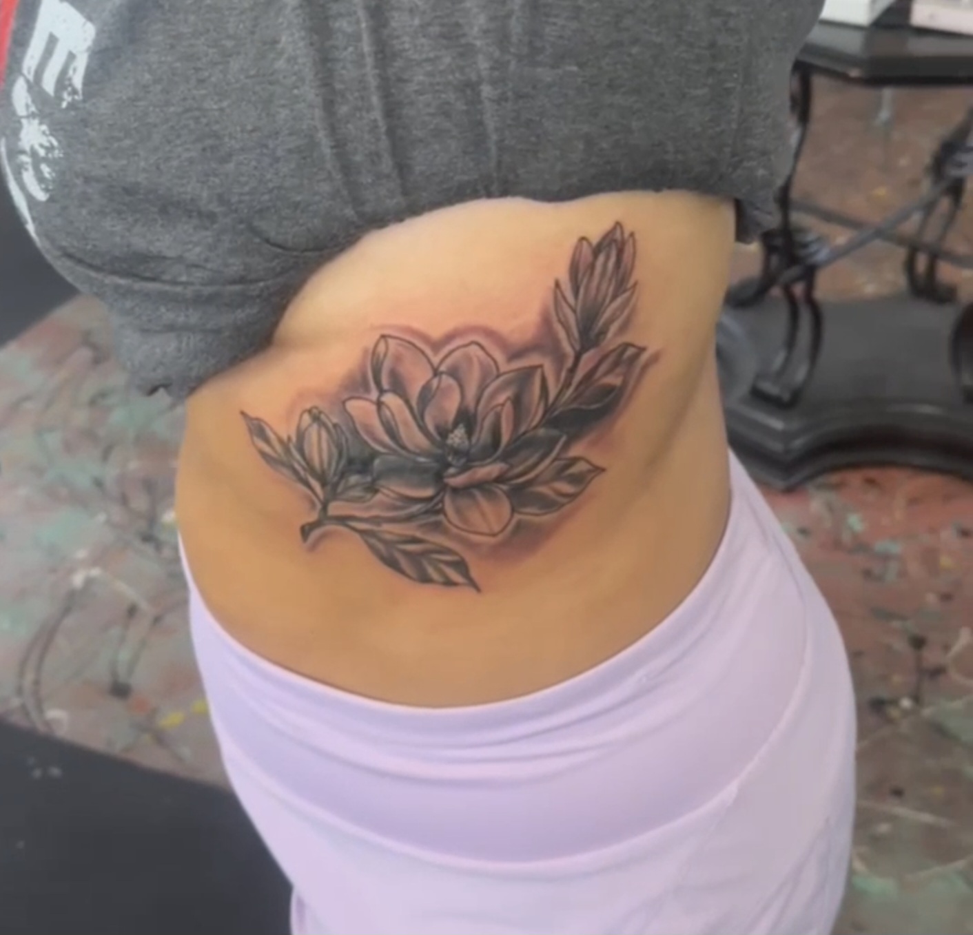 Magnolia flower tattoo on the ribs